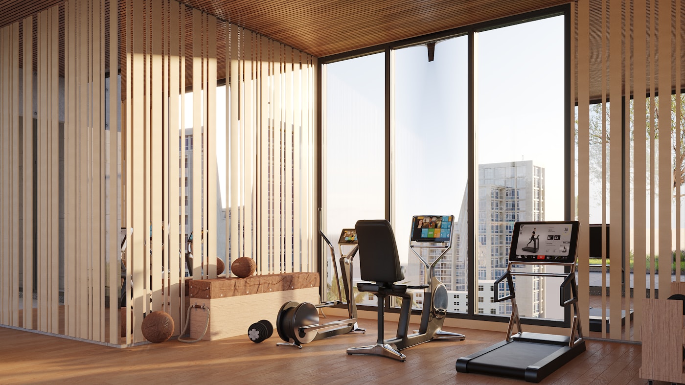 A modern fitness space with equipment and a city view