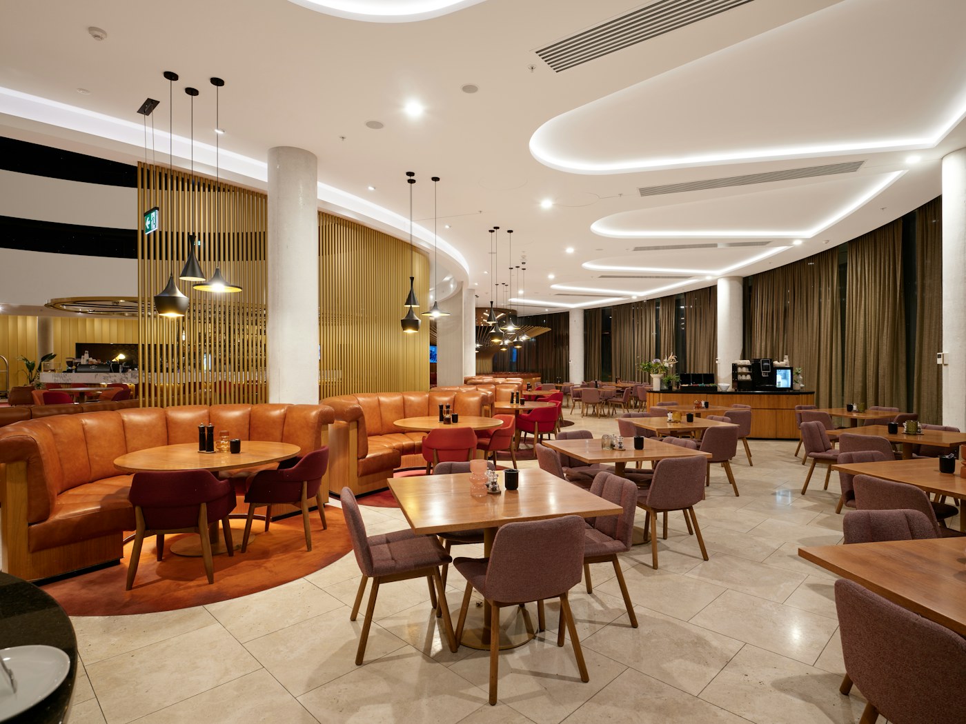 A bright contemporary hotel lounge with curved ceiling lights